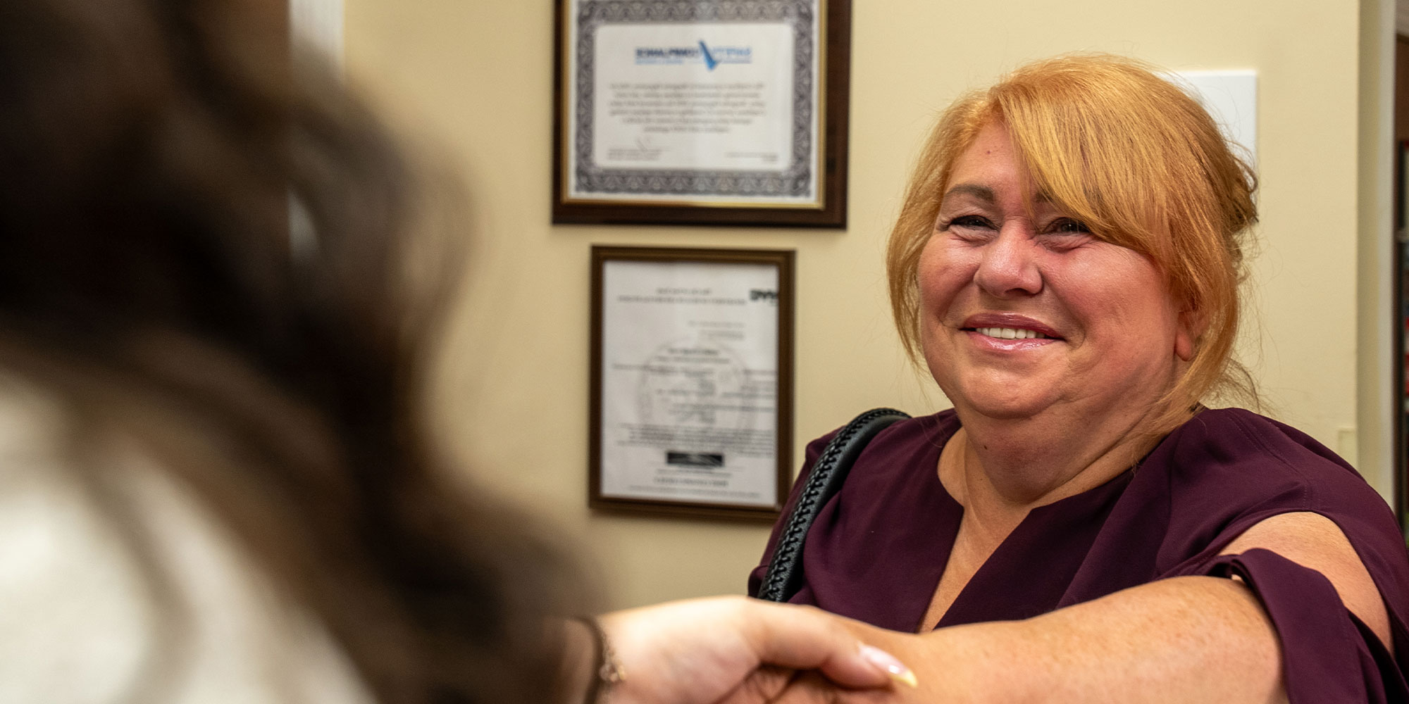 insurance handshake front desk hero