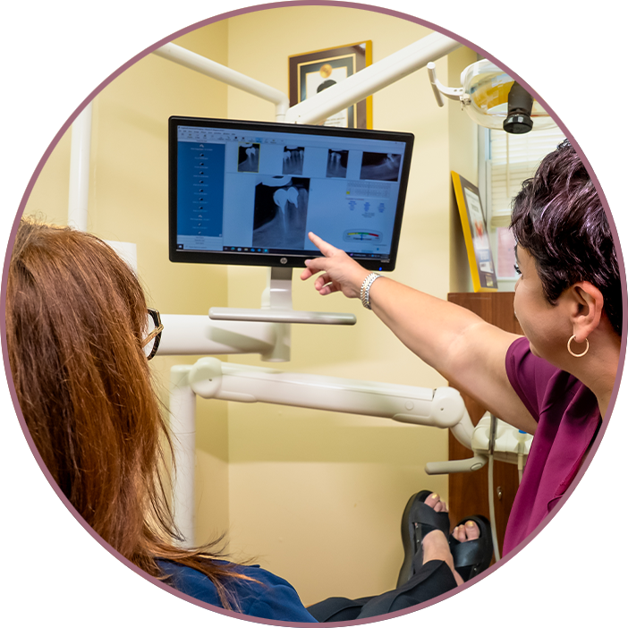 Doctor pointing at x-ray of Patients tooth