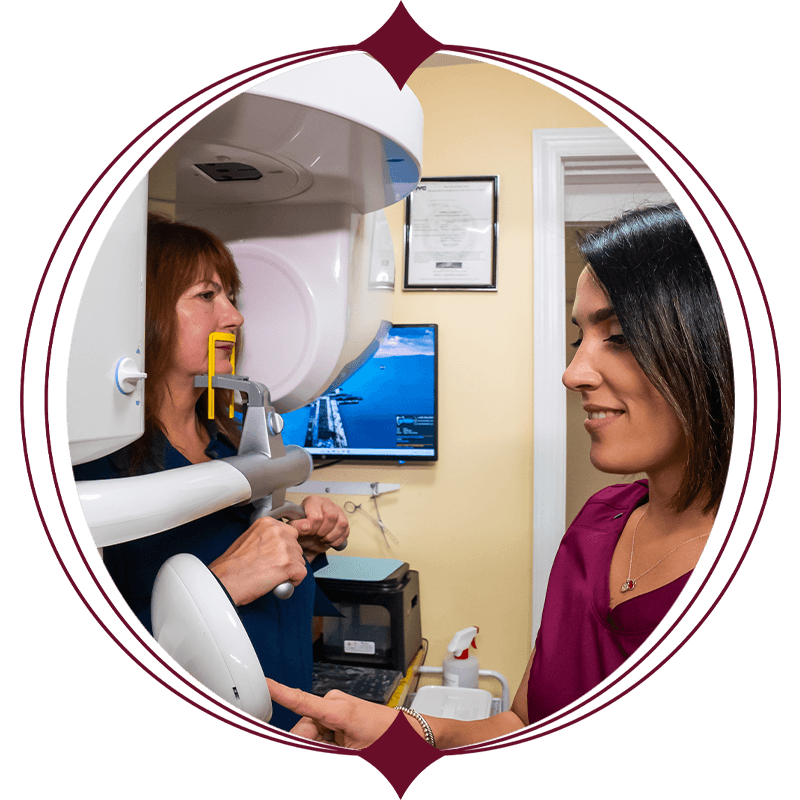team member taking a dental scan of patient